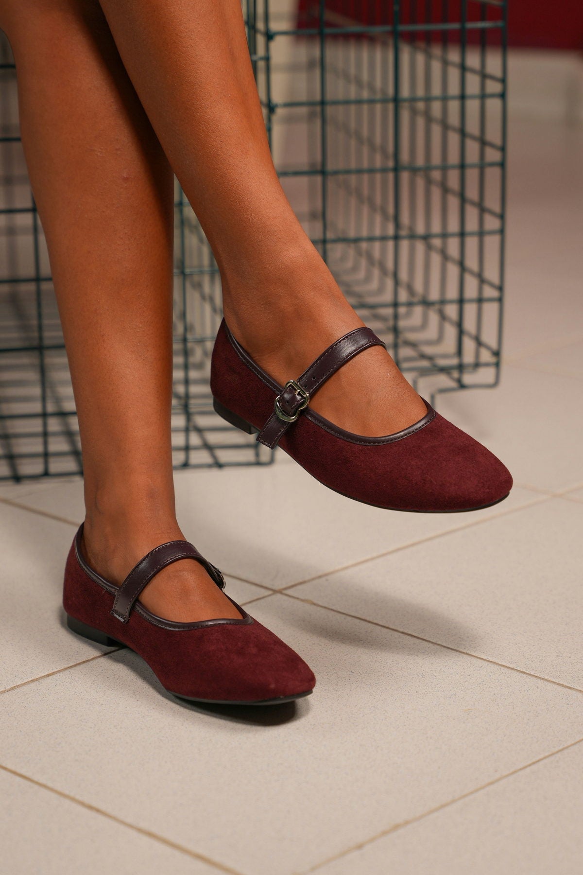 Burgundy suede mary-jane flats with a buckle strap
